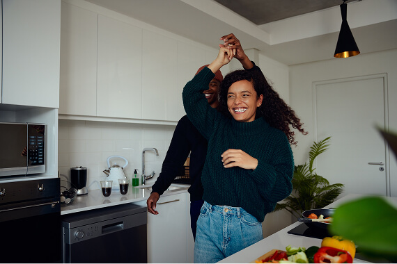Happy couple dancing in a modern kitchen
