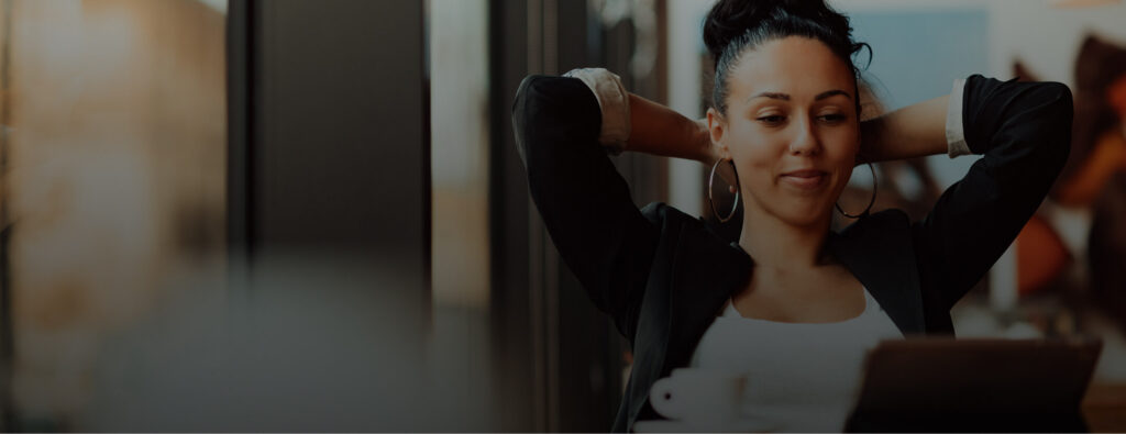Woman looking relaxed while working on a device