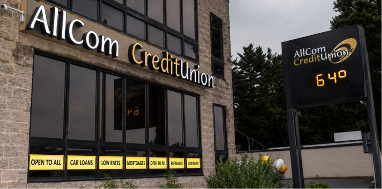 Exterior of AllCom CreditUnion building with signs for services and 640 on a separate sign