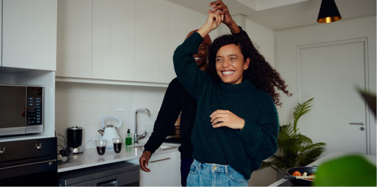 Happy couple dancing in a modern kitchen